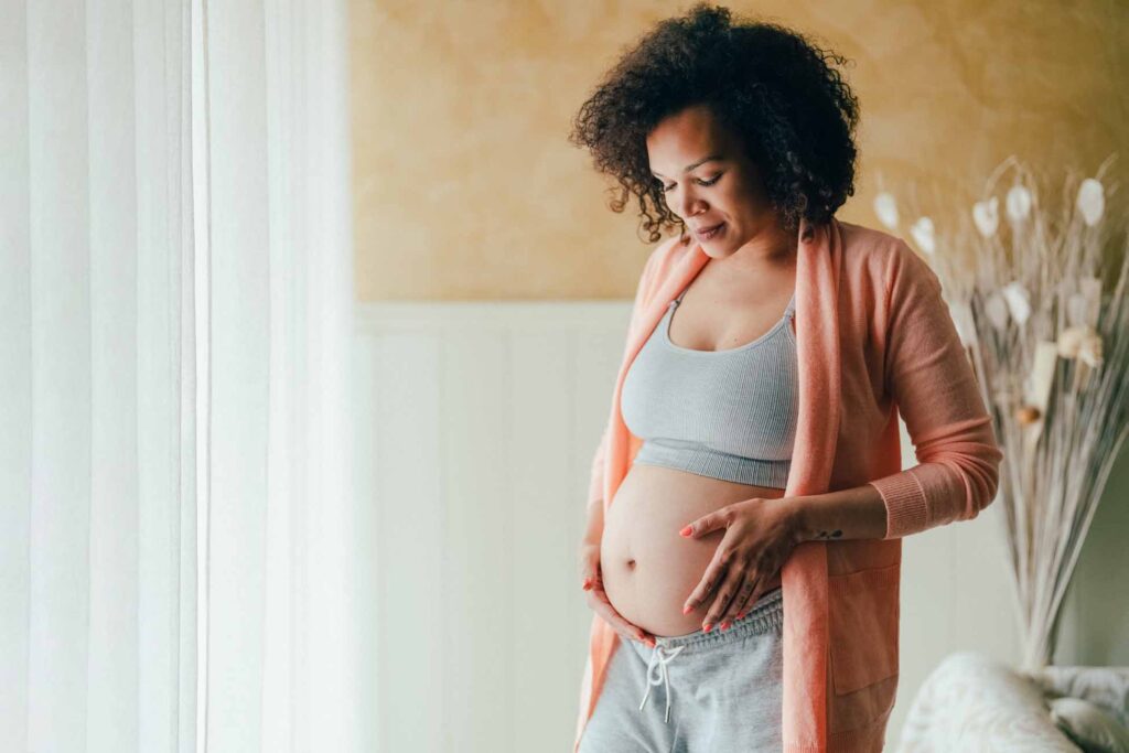 Pregnant woman cradling belly