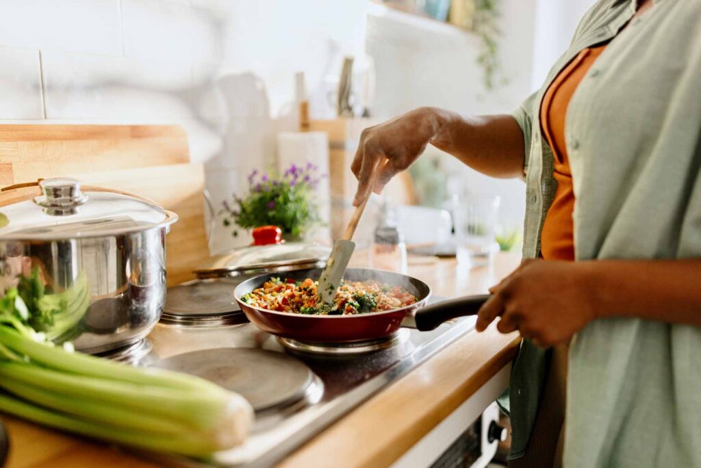 Woman preparing quinoa and mixed vegetables
