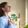 Women taking a breath and meditating while standing