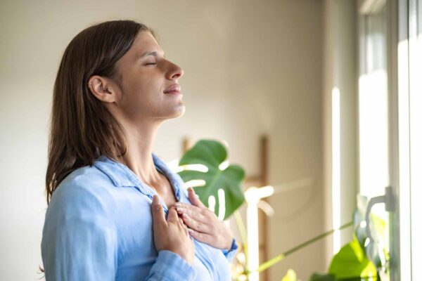 Women taking a breath and meditating while standing