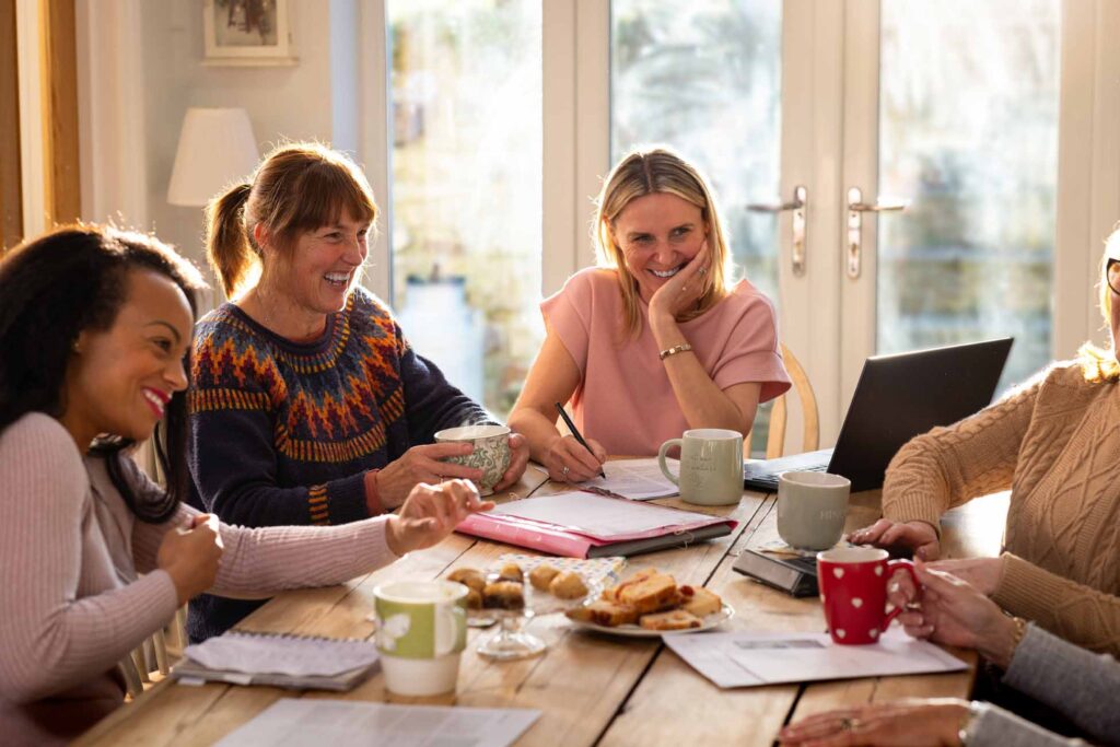 Women laughing around a table