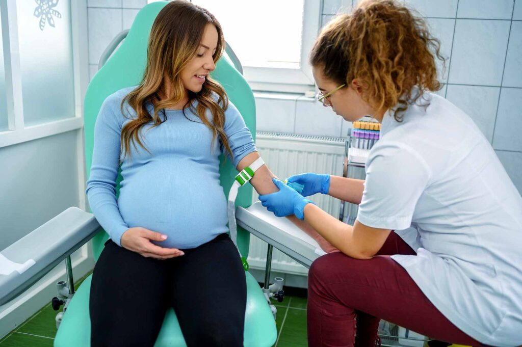 Nurse taking blood from a pregnant woman