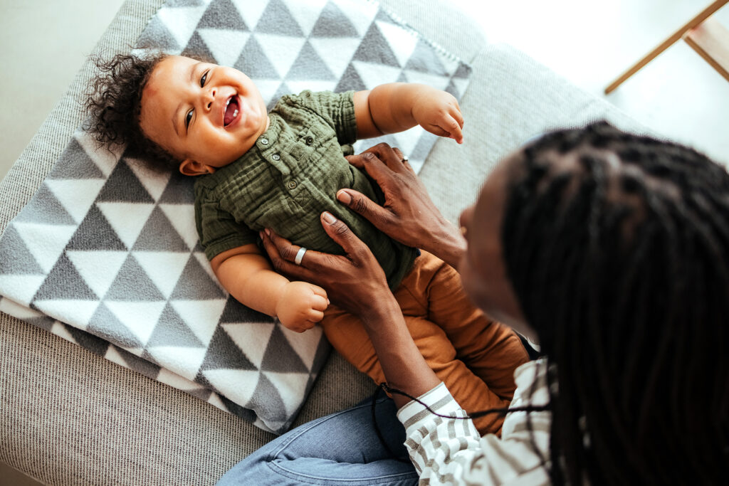 Black woman playing with her baby boy